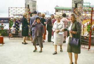 People at entrance gates to Tai Pak floating restaurant, Castle Peak, New Territories, Hong Kong,