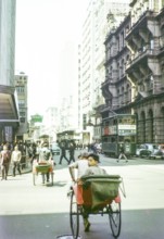 Human rickshaws and green double-decker trolleybus trams, Hong Kong, Asia 1964