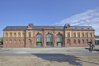Old Post Office built in 1893 and sculpture of a woman wearing shoes, monument to the former shoe