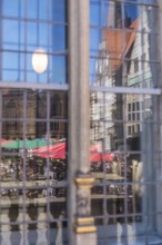 Market square, Old Town Hall and historic houses reflected in the window of the Bremen Chamber of