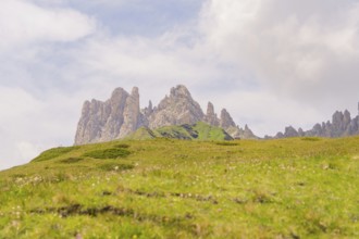 Majestic mountains under the clouds on a green meadow, Alpe di Siusi, Dolomites, South Tyrol, Italy