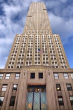 Empire State Building with US flag, New York City, USA
