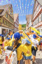 A festive group with flags in a decorated alleyway in the old town centre, 950 years of Calw, Calw