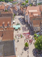 Aerial view of an old town with half-timbered houses and a gathering of people, 950 years of Calw,
