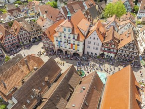 People on a square surrounded by half-timbered houses at a festival, summer day, 950 years Calw,