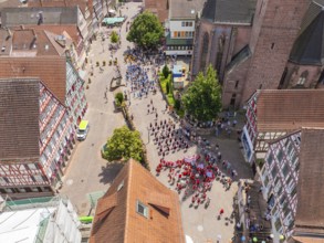Aerial view of a lively parade through a historic town in sunny weather, 950 years of Calw, Calw