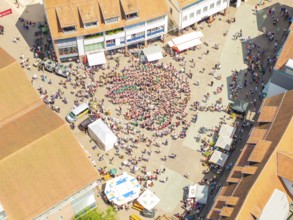 Vivid aerial view of a square where a crowd is taking part in a public celebration, 950 years of