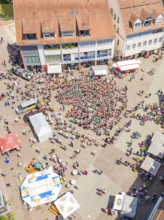 Aerial view of a square with a crowd of people and surrounding buildings, 950 years of Calw, Calw