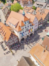 Crowds of people at an event in a central city area with historic buildings, 950 years of Calw,