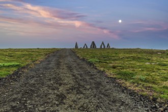 Gravel path to the Arctic Henge, large stone gates, basalt, landmark in barren landscape,
