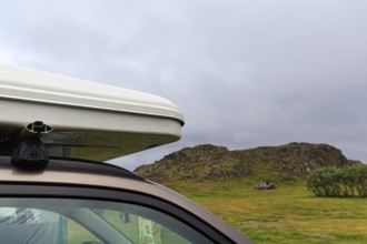 Rooftop tent on car roof in volcanic landscape, detail, camping site, rain clouds, Bakkagerdi,