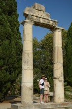Two people posing in front of ancient columns and green trees, Ancient Agora, Kos Town, Kos,