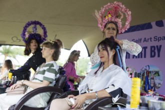 Festival visitors get their hair styled at Fashionpalooza at the Lollapalooza Festival in the