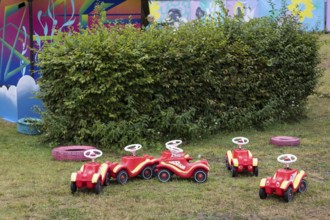 Unused bobby cars are parked in a corner of the Kidzapalooza at the Lollapalooza Festival in the