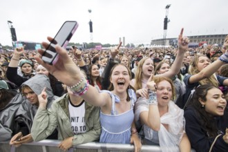 Festival visitors celebrate Mark Ambor's performance at the Lollapalooza Festival in the