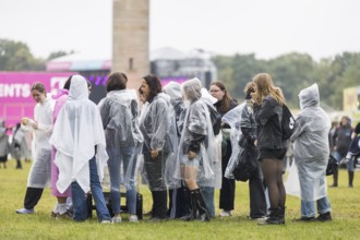 Festivalgoers with rain capes at the Lollapalooza Festival in the Olympiastadion and on the
