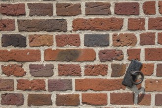 Detail of a brick wall, brick wall with a rusty metal ring, Münsterland, North Rhine-Westphalia,