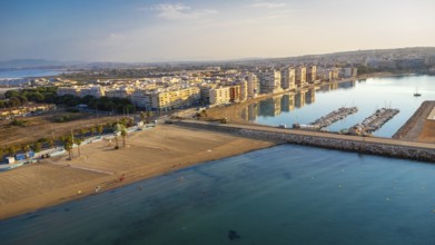Aerial view of torrevieja coastline reflecting in mediterranean sea at sunrise, featuring acequion