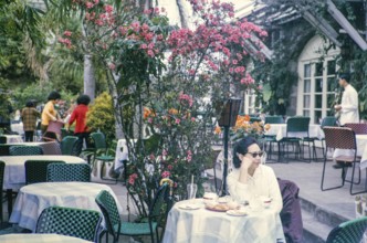 Woman sitting at table of restaurant at the Peak, Hong Kong, Asia, 1964