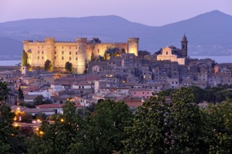 Fortress Castello Odescalchi, Duomo Santo Stefano, illuminated, blue hour, behind Bracciano Lake,