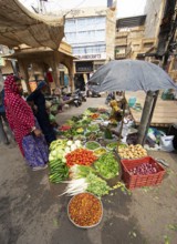Indian woman at a market stall in the old town of Jaisalmer, Rajasthan, India