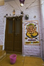Colourful Ganesha image next to a front door in the fortress of Jaisalmer, Rajasthan, India