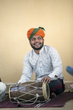 Rajasthani folk musician with a dhol or tubular drum, Jaisalmer, Rajasthan, India