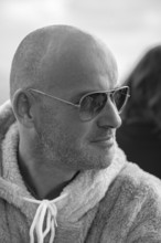 Portrait of a young man with sunglasses and fluffy jacket, black and white, Baden-Württemberg,