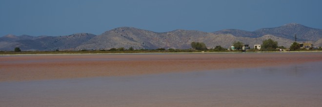 Vast landscape with mountains and huts by the lake, clear sky offered, salt lake, Tigaki, nature