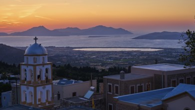 A church at sunset with a view of the sea and the islands, salt lake, Tigaki, nature reserve, hydro