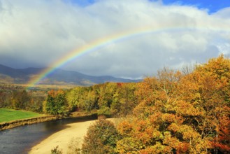 Scenic river landscape with rainbow, Saco River in Mount Washington Valley, fall leaves, Indian