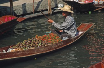 Merchant in his boat at Damnoen Saduak Floating Market, Thailand, December 2002, vintage, retro,
