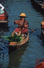 Merchant in her boat at Damnoen Saduak Floating Market, Thailand, December 2002, vintage, retro,