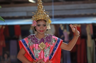 Young person wearing Thai drama clothes at Damnoen Saduak Floating Market, Thailand, December 2002,