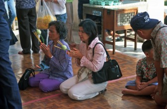 People, woman praying, Phra Mongkhonbophit, Ayutthaya, Thailand, December 2002, vintage, retro,