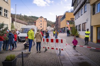 Busy street scene in the city with people talking and a roadblock, Triathlon, Calw, Germany