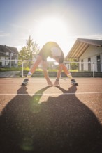 Person stretching on sunny track, triathlon, Calw, Germany