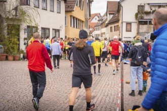 Group of people in sportswear on paved village road, triathlon, Calw, Germany