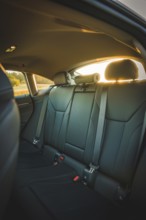 Interior view of car with back seats in sunset light, BMW i7 electric car, Deer E- Carsharing,