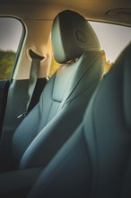 Close-up view of a comfortable and stylish car seat in the interior with dim lighting, BMW i7