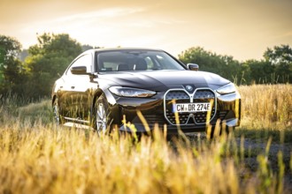 BMW in the field at sunset with natural backdrop, BMW i7 electric car, Deer e-Carsharing, Calw,