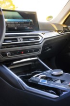 Detailed view of a modern car interior with display and steering wheel, BMW i7 electric car, Deer