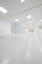 Minimalist gallery space with hanging metal artwork in the foreground, Schauwerk, Sindelfingen,