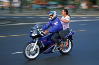 Man and woman on motorcycle, motion-blurred, Bangkok, Thailand, December 2002, vintage, retro, old,