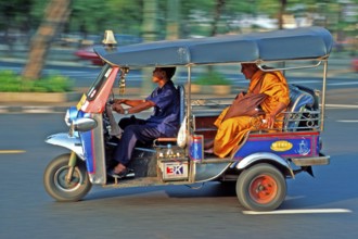 Monk in a three-wheeled tuk tuk taxi, blurred, Bangkok, Thailand, December 2002, vintage, retro,