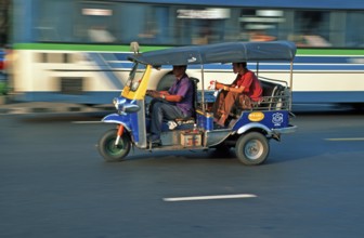 Passenger in a three-wheeled tuk tuk taxi, blurred, Bangkok, Thailand, December 2002, vintage,