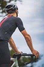 Close-up of cyclist looking at handlebars and concentrating, triathlon, Calw, Germany