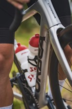 Close-up of a bicycle frame with distinctive water dispenser bottles, Triathlon, Calw, Germany