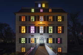 The windows of the Holzhausenschlösschen in Holzhausenpark in Frankfurt am Main shine brightly in