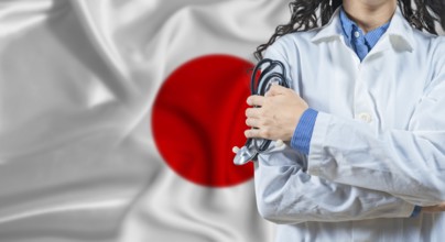 Healthcare professional with Japan flag background. Professional doctor holding stethoscope on